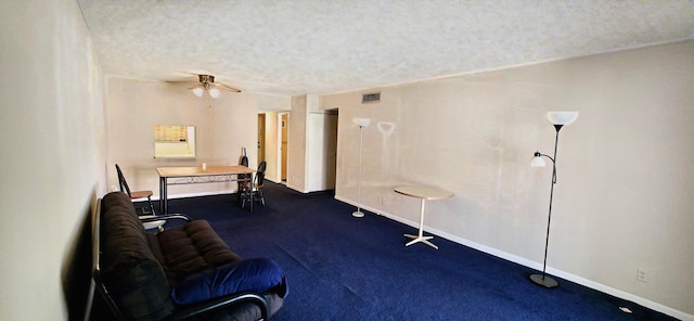 sitting room with ceiling fan and a textured ceiling