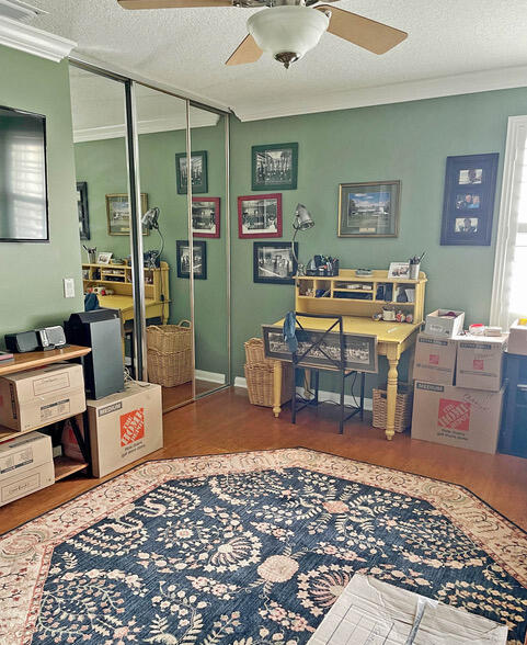 home office with a textured ceiling, a wealth of natural light, crown molding, and ceiling fan