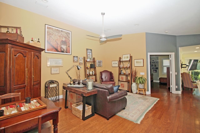 living room with hardwood / wood-style floors and ceiling fan