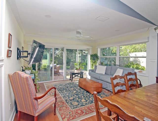 sunroom / solarium featuring ceiling fan