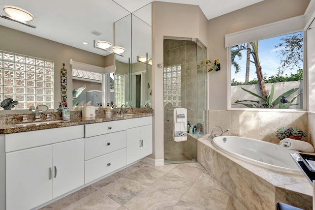 bathroom featuring vanity and shower with separate bathtub