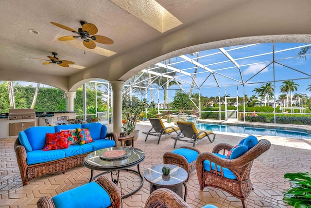 view of patio with an outdoor kitchen, a lanai, an outdoor living space, ceiling fan, and grilling area