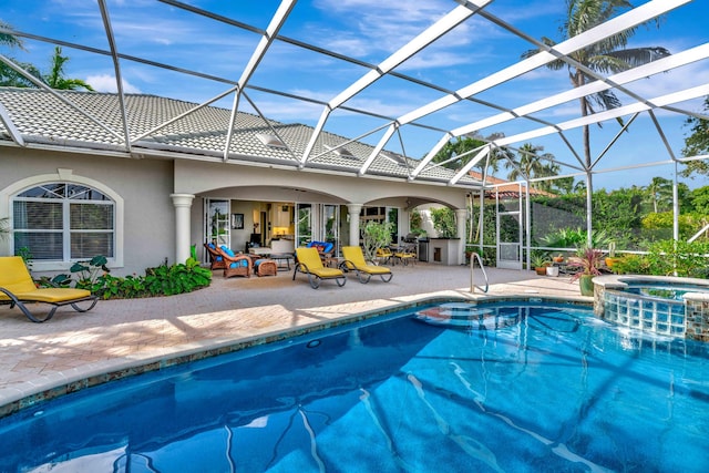 view of swimming pool with glass enclosure, a patio area, and an in ground hot tub