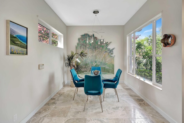 dining room with plenty of natural light and a chandelier