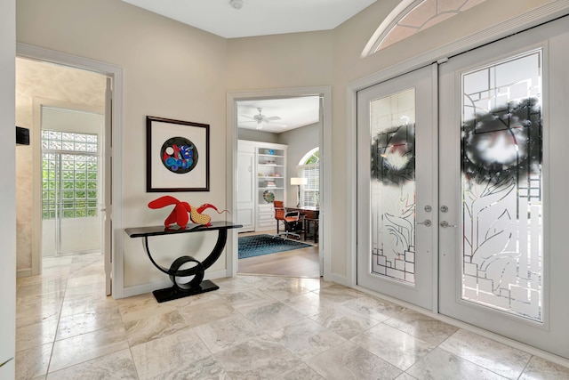 entryway with ceiling fan, french doors, and light wood-type flooring