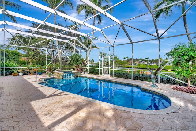 view of swimming pool featuring an in ground hot tub, glass enclosure, and a patio area