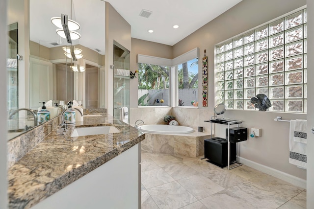 bathroom with vanity, tiled bath, and heating unit