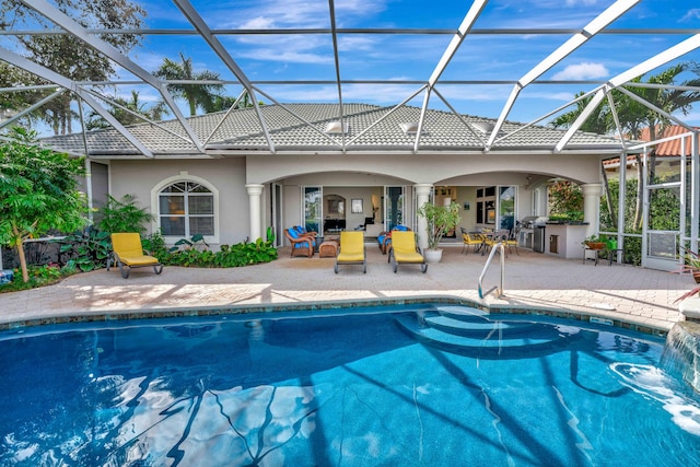 view of swimming pool with glass enclosure, a patio, and grilling area