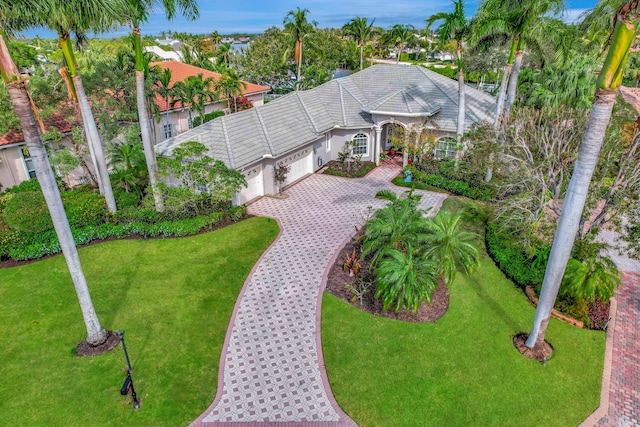 view of front of property featuring a garage and a front lawn