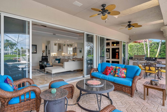 view of patio with grilling area, an outdoor living space, and ceiling fan