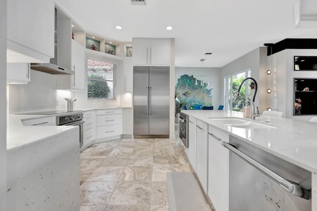 kitchen featuring white cabinets, stainless steel appliances, a wealth of natural light, and sink