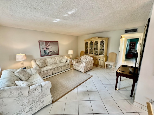 living room featuring light tile patterned floors and a textured ceiling