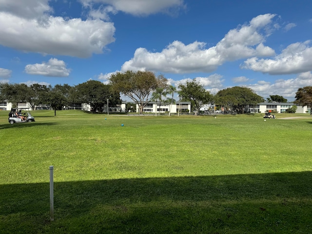 view of home's community with a yard