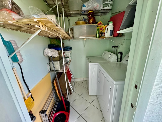 laundry room featuring light tile patterned floors and separate washer and dryer