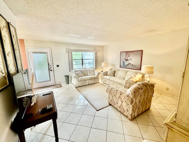 living room featuring light tile patterned floors and a textured ceiling