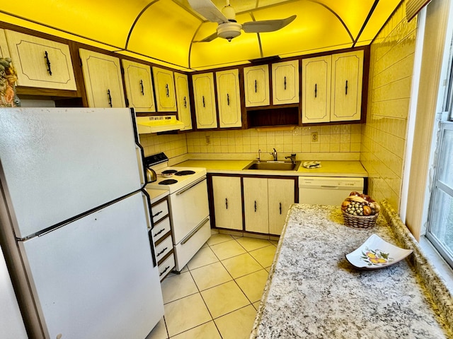 kitchen with white appliances, ceiling fan, sink, light tile patterned floors, and range hood