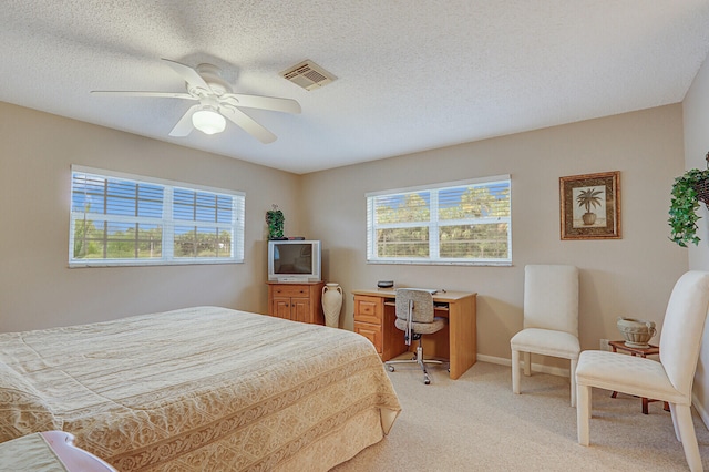 bedroom with light carpet, a textured ceiling, and ceiling fan