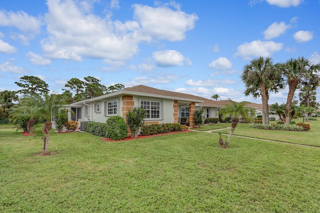 single story home featuring a front lawn