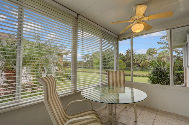 unfurnished sunroom with ceiling fan