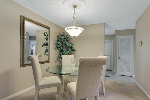 carpeted dining space with a textured ceiling