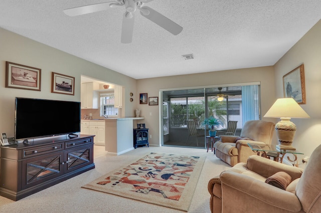 carpeted living room featuring a textured ceiling