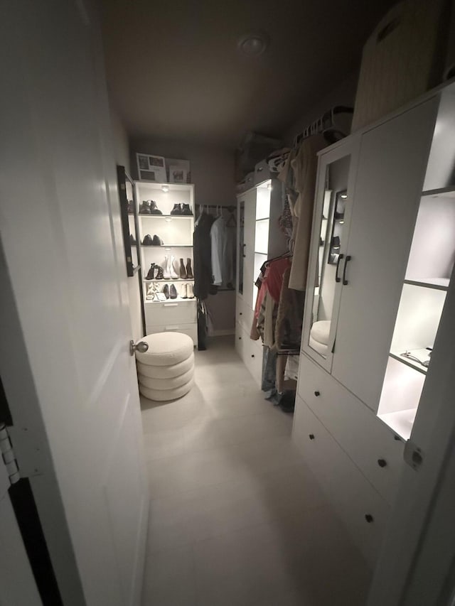 kitchen with ceiling fan, sink, black appliances, a center island with sink, and white cabinets