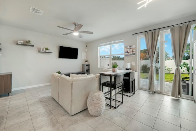 tiled living room featuring ceiling fan