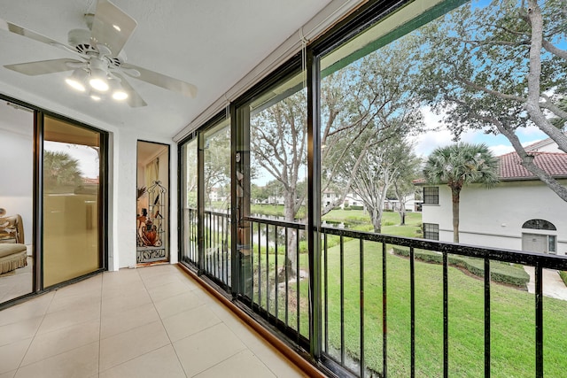 unfurnished sunroom with ceiling fan and a wealth of natural light