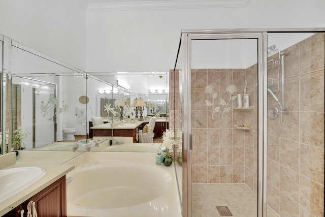 full bathroom with vanity, toilet, ornamental molding, and independent shower and bath