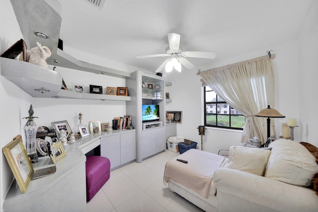 living room with a textured ceiling and ceiling fan