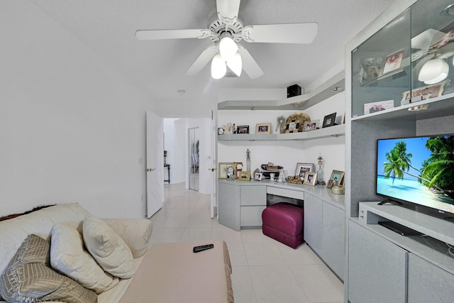 kitchen featuring ceiling fan, built in desk, and light tile patterned floors