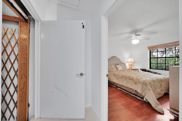 bedroom with ceiling fan and light hardwood / wood-style floors