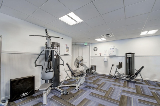 workout area with a paneled ceiling