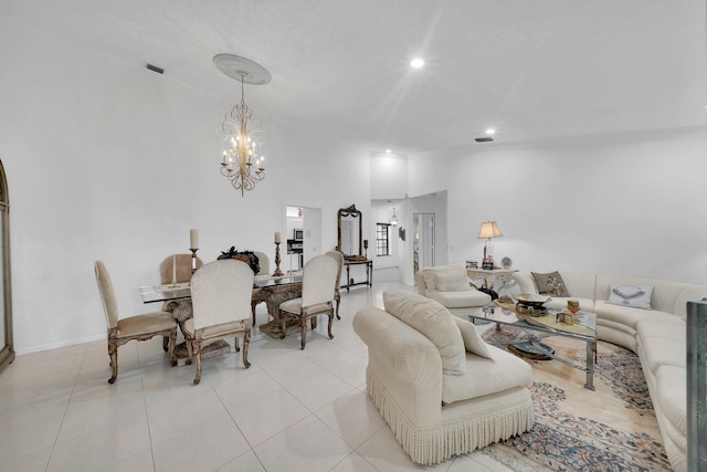 living room with light tile patterned floors and an inviting chandelier