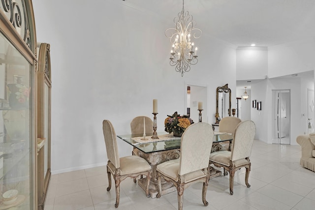 dining area featuring light tile patterned floors, crown molding, a high ceiling, and a chandelier