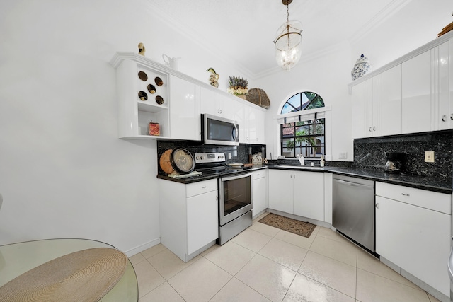 kitchen featuring backsplash, decorative light fixtures, white cabinetry, and stainless steel appliances