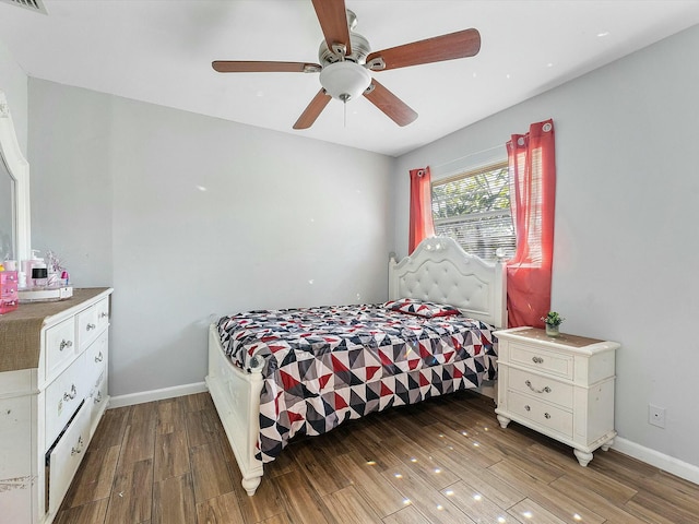 bedroom with ceiling fan and dark hardwood / wood-style flooring