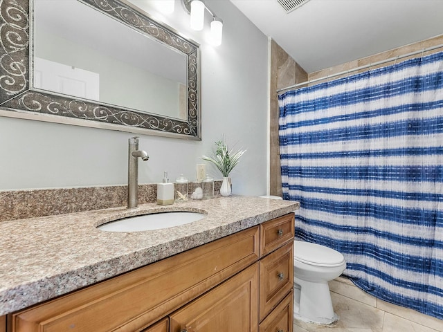 bathroom featuring tile patterned flooring, vanity, toilet, and curtained shower