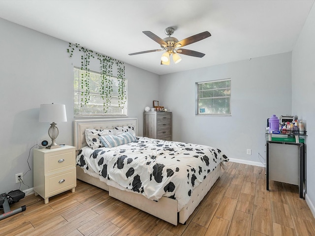 3561 Oberon Ave, Boynton Beach, FL 33436 - bedroom with light wood-type flooring, multiple windows, baseboards, and a ceiling fan