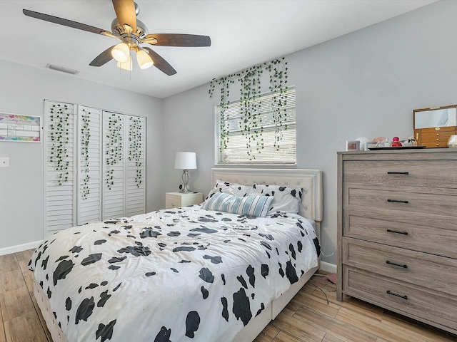 bedroom with ceiling fan and light hardwood / wood-style flooring