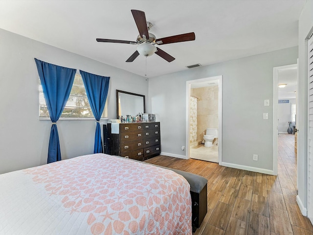 bedroom with hardwood / wood-style flooring, ensuite bath, and ceiling fan