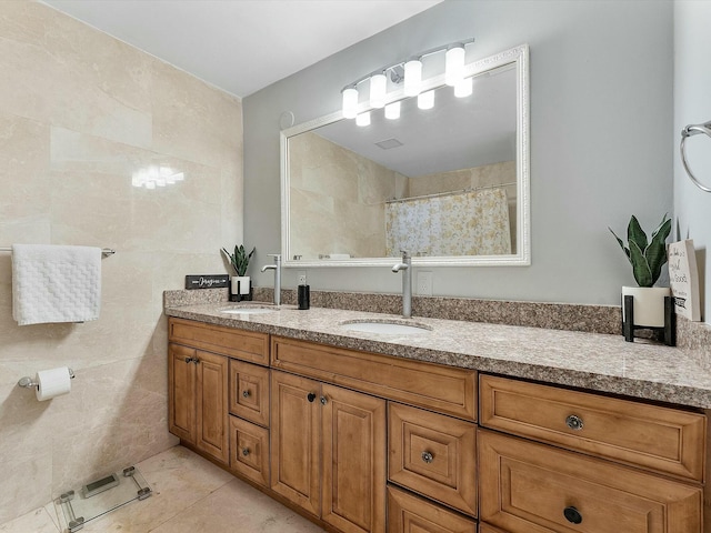 bathroom featuring tile patterned floors, vanity, and tile walls