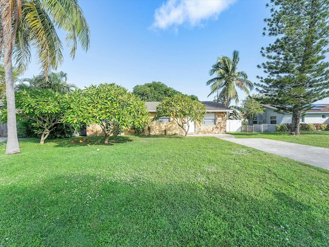 3561 Oberon Ave, Boynton Beach, FL 33436 - view of property hidden behind natural elements featuring concrete driveway and stone siding