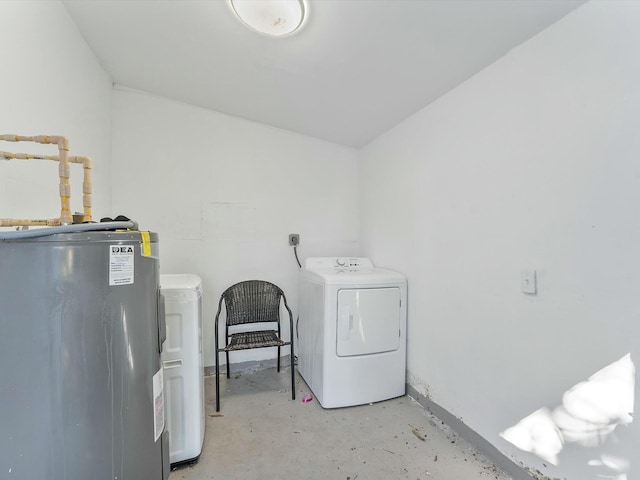 washroom with electric water heater and washer and dryer