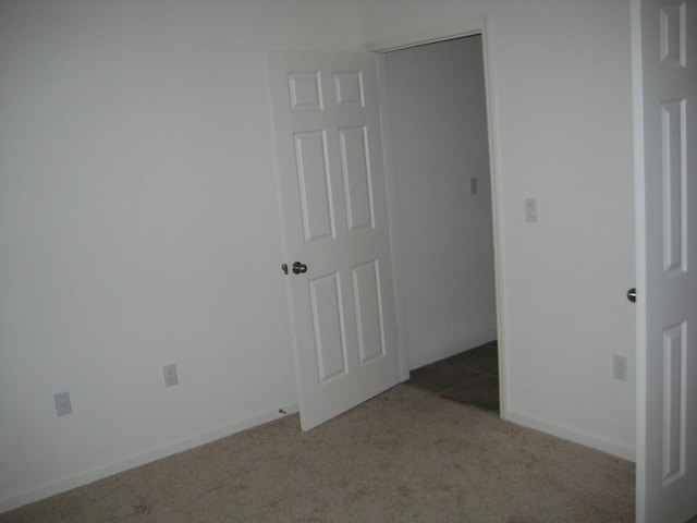 interior space with light carpet and a closet