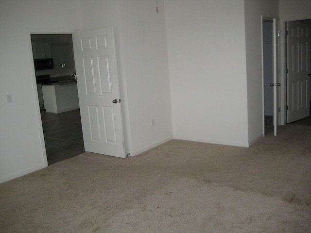 carpeted empty room with sink