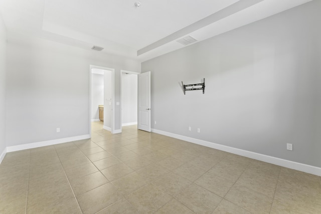 spare room featuring light tile patterned flooring