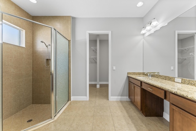 bathroom featuring tile patterned floors, vanity, and walk in shower