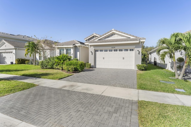 view of front of home featuring a garage and a front yard