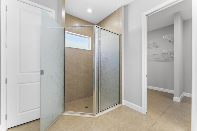 bathroom with tile patterned flooring and a shower with door